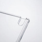 Close-up of a transparent acrylic or glass frame corner with a U-shaped hook or loop detail, shown on a clean white background.