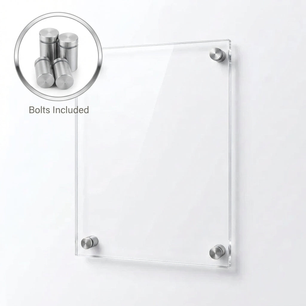 A clear rectangular acrylic or glass wall plaque mounted with four silver metal studs on a plain white wall.