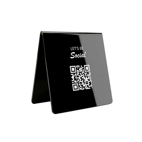 A glossy black acrylic A-frame tabletop sign with white text reading 'LET'S BE Social' above a QR code, shown on a clean white background.