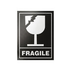 A rectangular black and white FRAGILE warning sign featuring a broken wine glass icon and the word 'FRAGILE' in bold white letters on a black background, centered on a light gray studio background.