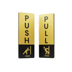 Two vertical emergency exit signage panels on a light gray background. The left panel is yellow with the word 'PUSH' in black and a black icon at the bottom indicating pushing a door.
